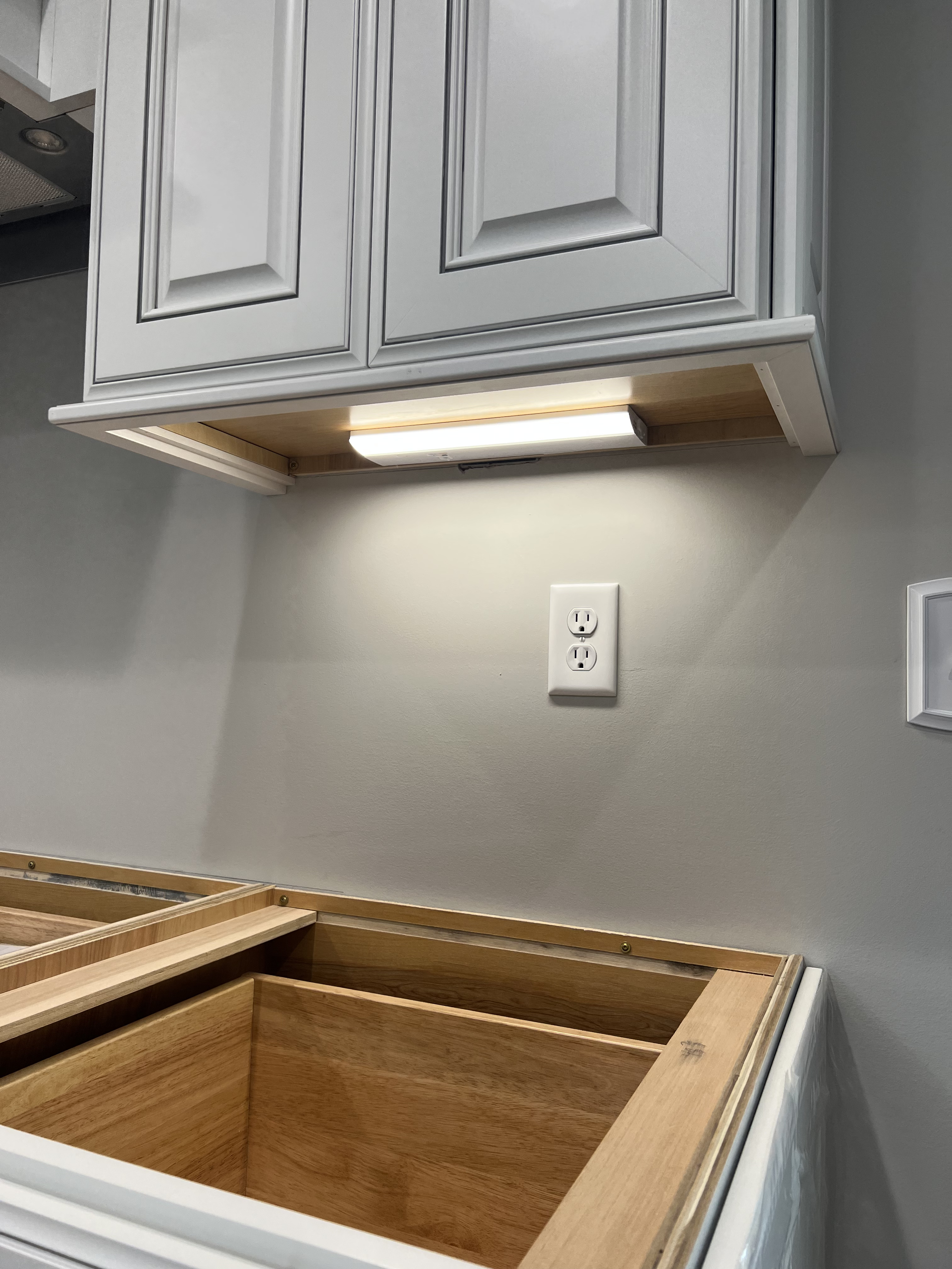 Installation of under cabinet lighting in kitchen